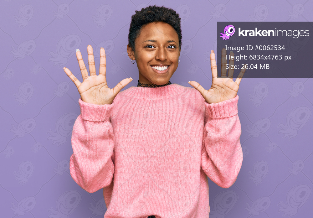 Young african american woman wearing casual clothes showing and pointing up with fingers number ten while smiling confident and happy. 