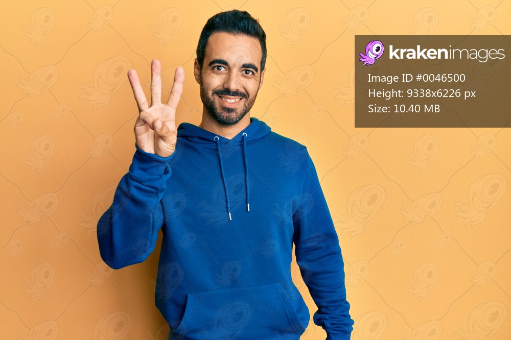 Young hispanic man wearing casual clothes showing and pointing up with fingers number three while smiling confident and happy. 