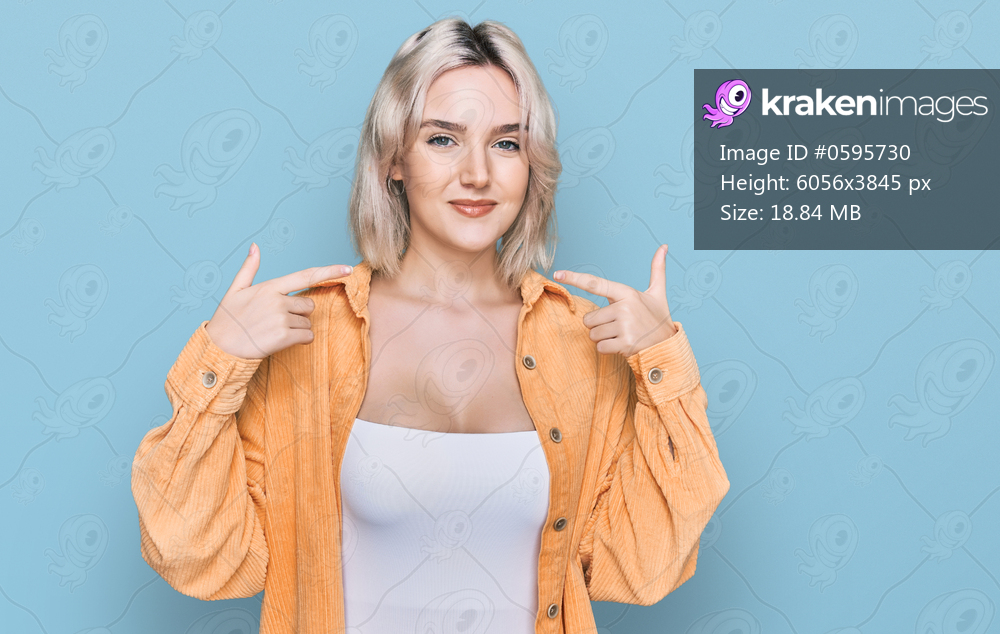Young blonde girl wearing casual clothes looking confident with smile on face, pointing oneself with fingers proud and happy. 