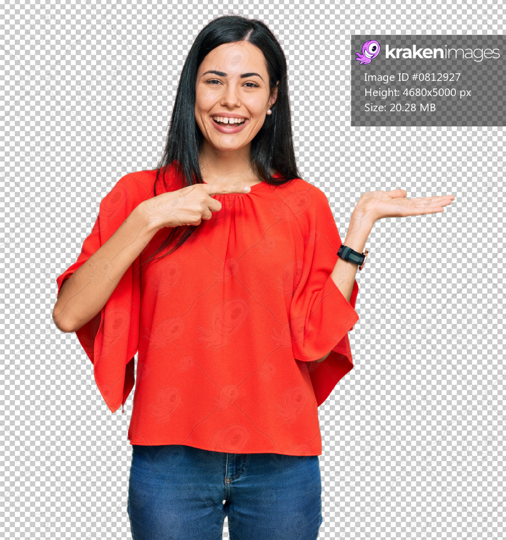 Beautiful young woman wearing casual clothes amazed and smiling to the camera while presenting with hand and pointing with finger.