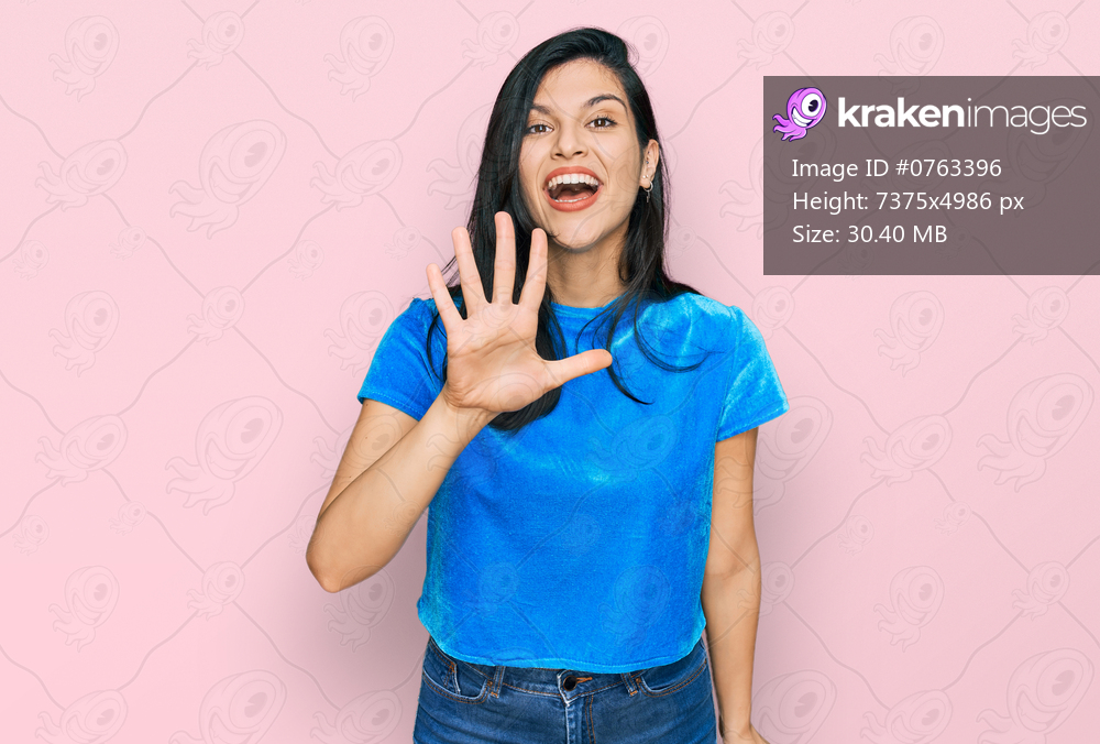 Young hispanic woman wearing casual clothes showing and pointing up with fingers number five while smiling confident and happy. 