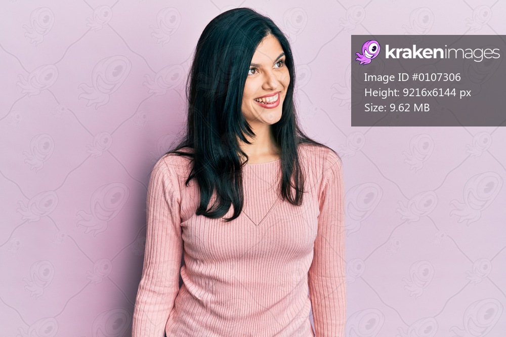 Young hispanic woman wearing casual clothes looking to side, relax profile pose with natural face and confident smile. 