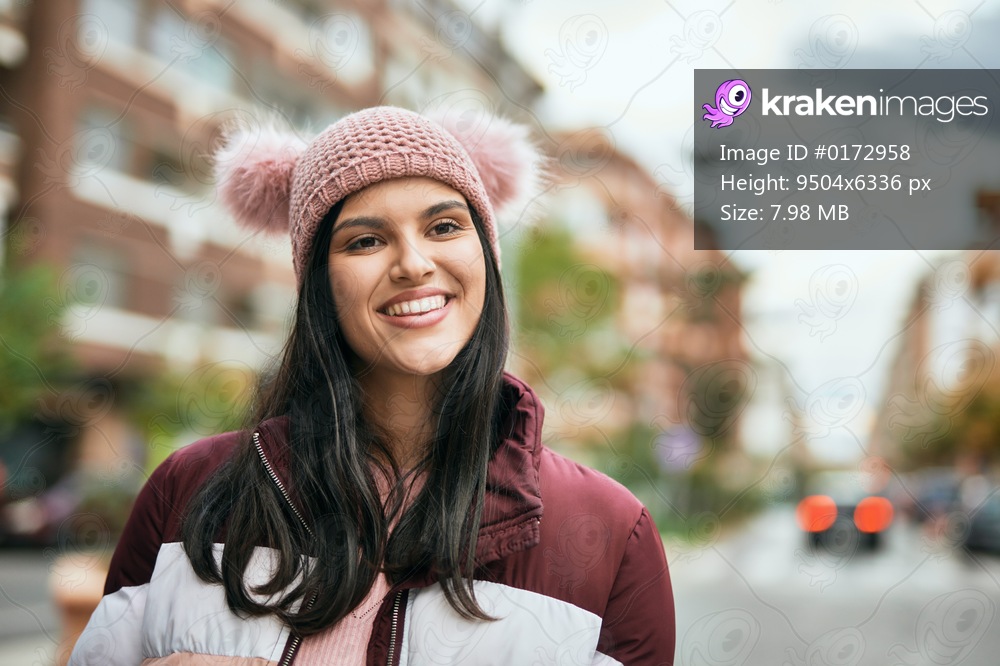 Young hispanic girl smiling happy standing at the city.