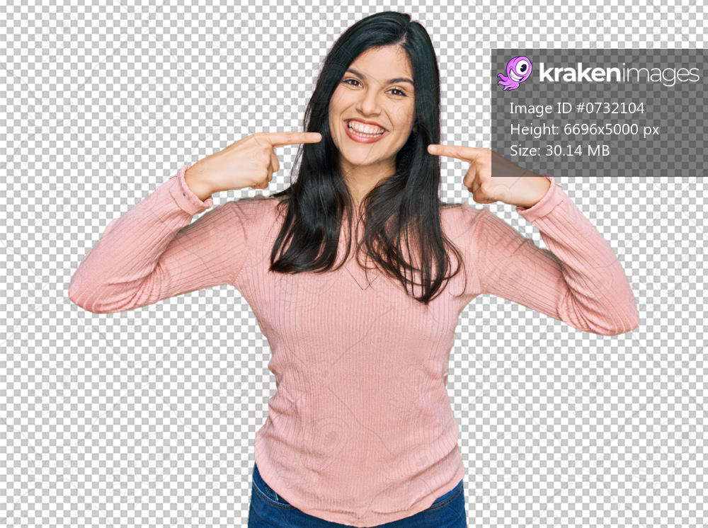 Young hispanic woman wearing casual clothes smiling cheerful showing and pointing with fingers teeth and mouth. dental health concept.