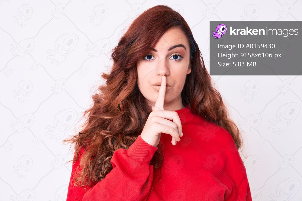 Young beautiful woman wearing casual clothes asking to be quiet with finger on lips. silence and secret concept. 