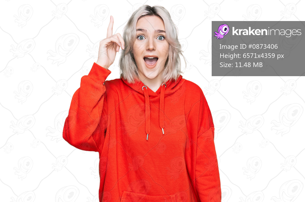 Young blonde girl wearing casual clothes pointing finger up with successful idea. exited and happy. number one. 