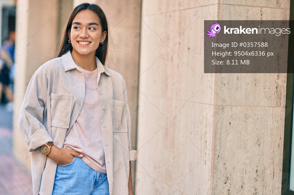 Young latin girl smiling happy standing at the city.