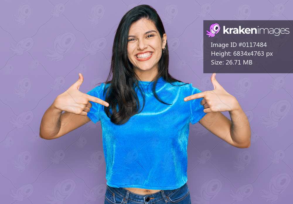 Young hispanic woman wearing casual clothes looking confident with smile on face, pointing oneself with fingers proud and happy. 