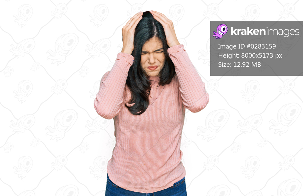 Young hispanic woman wearing casual clothes suffering from headache desperate and stressed because pain and migraine. hands on head. 
