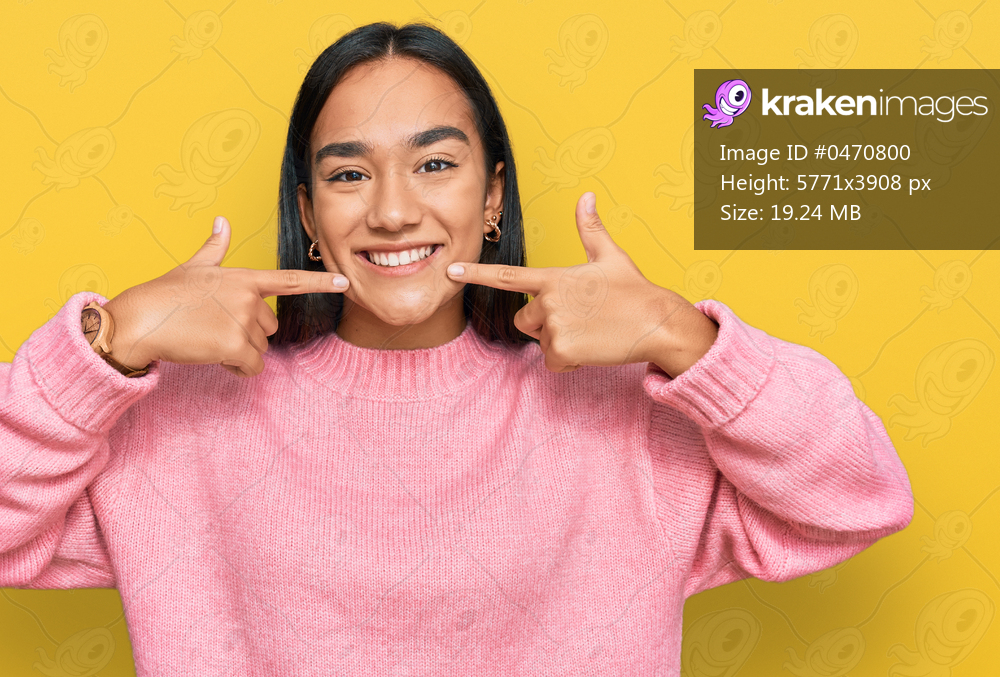 Young asian woman wearing casual winter sweater smiling cheerful showing and pointing with fingers teeth and mouth. dental health concept. 