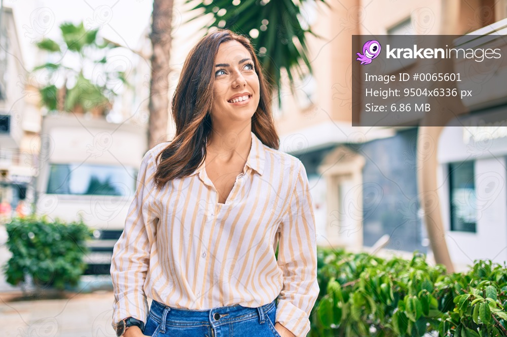 Young hispanic woman smiling happy walking at the city.