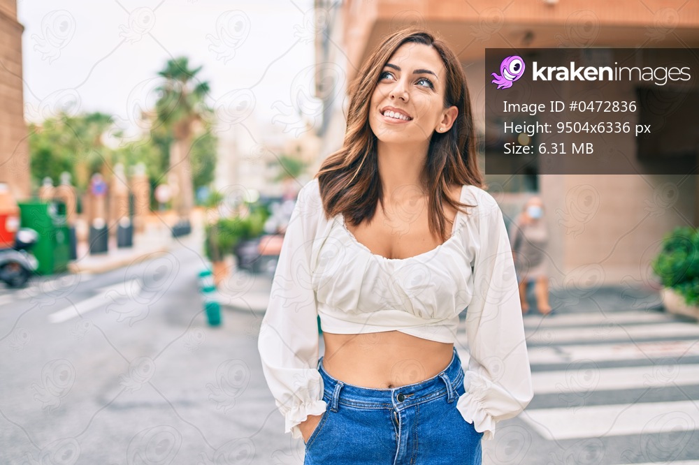 Young hispanic woman smiling happy walking at the city.