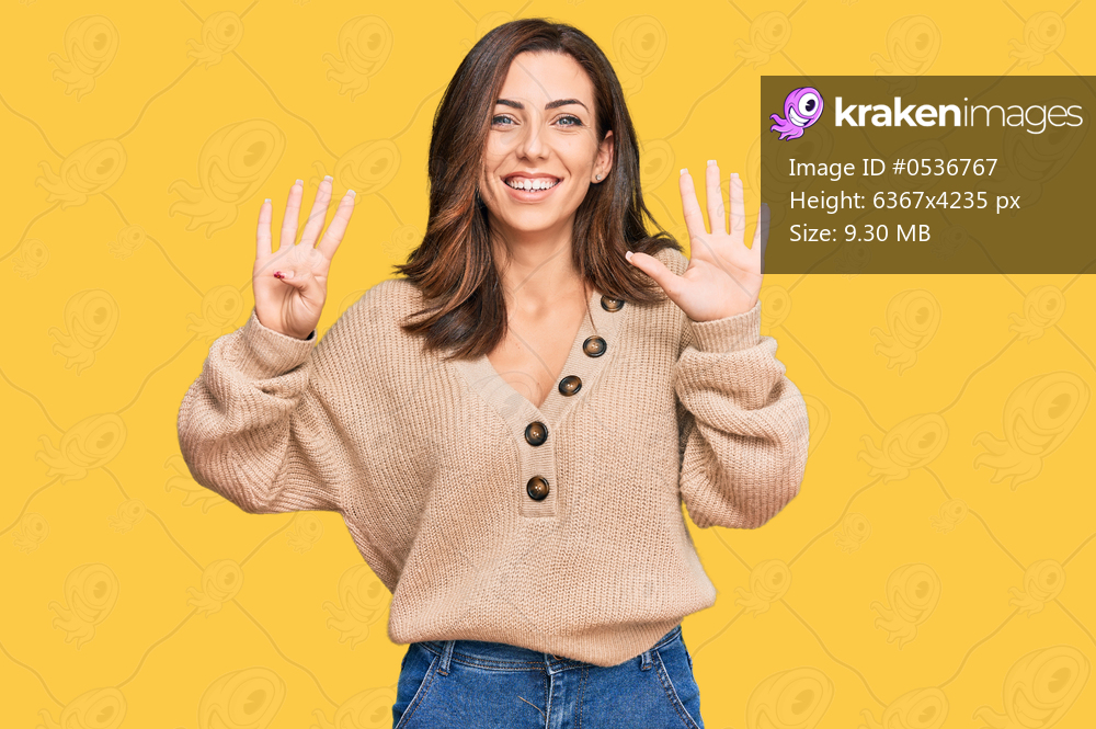 Young brunette woman wearing casual winter sweater showing and pointing up with fingers number nine while smiling confident and happy. 