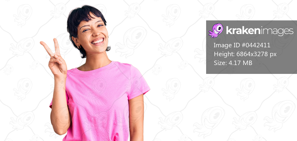 Young brunette woman with short hair wearing casual clothes showing and pointing up with fingers number two while smiling confident and happy. 