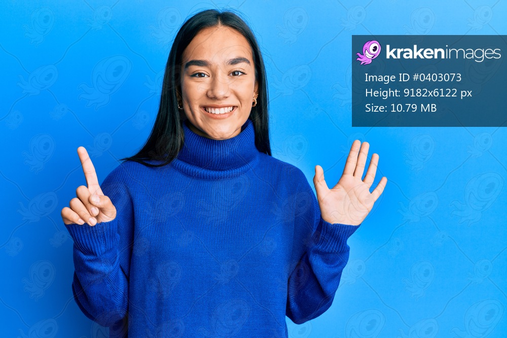 Young asian woman wearing casual winter sweater showing and pointing up with fingers number six while smiling confident and happy. 