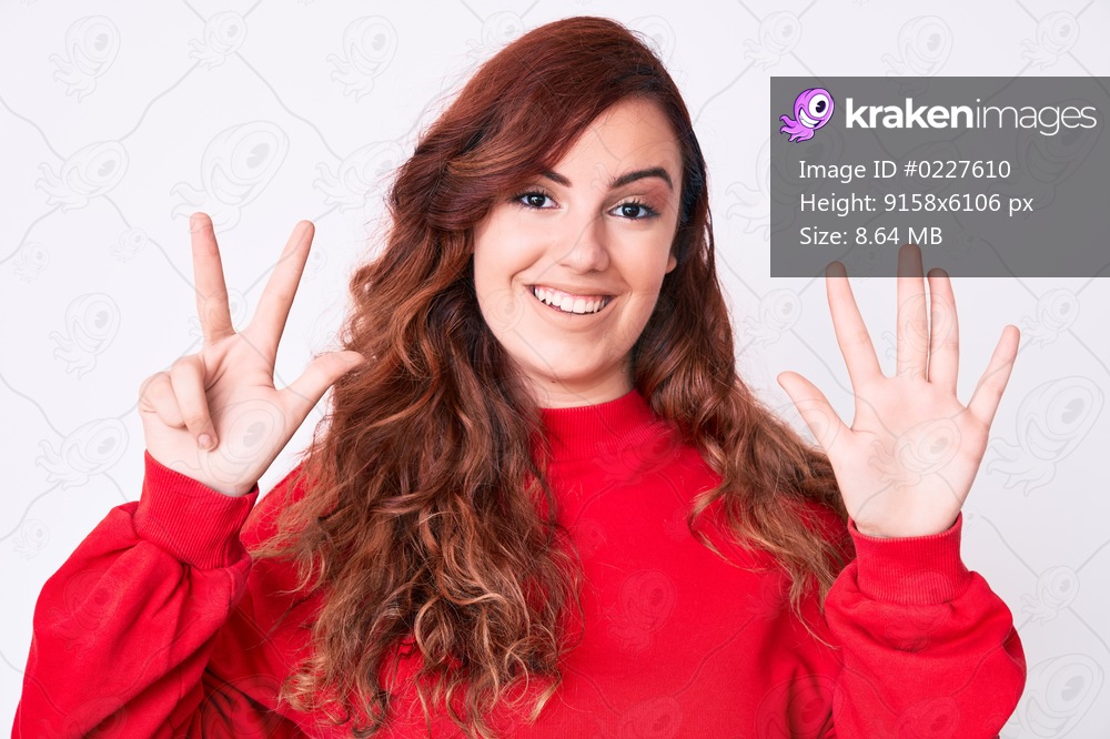 Young beautiful woman wearing casual clothes showing and pointing up with fingers number eight while smiling confident and happy. 