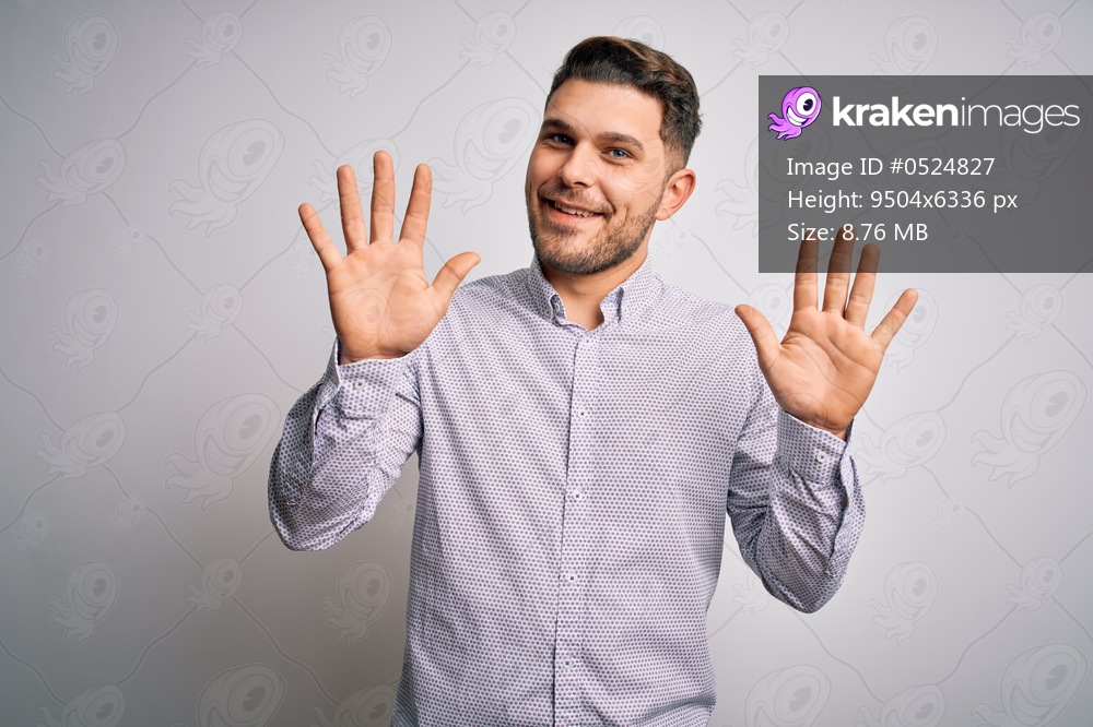 Young business man with blue eyes standing over isolated background showing and pointing up with fingers number ten while smiling confident and happy.