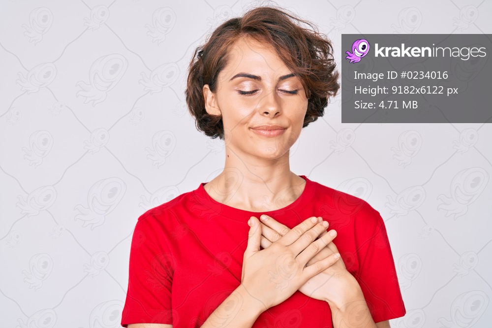 Young hispanic woman wearing casual clothes smiling with hands on chest, eyes closed with grateful gesture on face. health concept. 