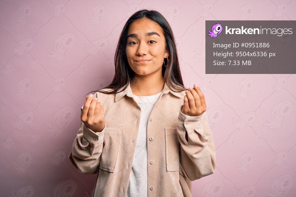 Young beautiful asian woman wearing casual shirt standing over pink background doing money gesture with hands, asking for salary payment, millionaire business
