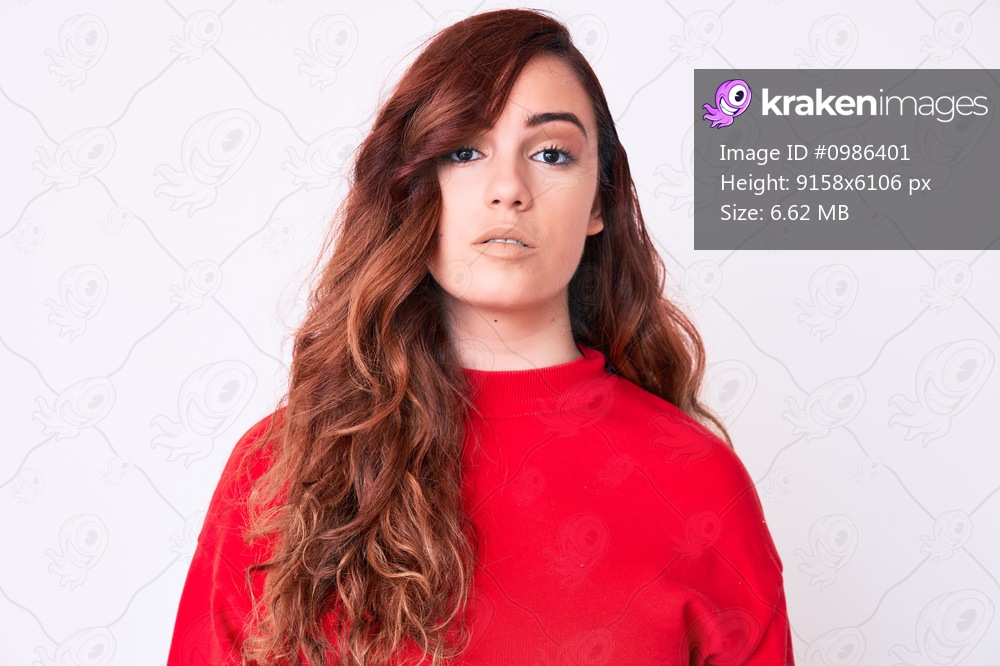 Young beautiful woman wearing casual clothes relaxed with serious expression on face. simple and natural looking at the camera. 