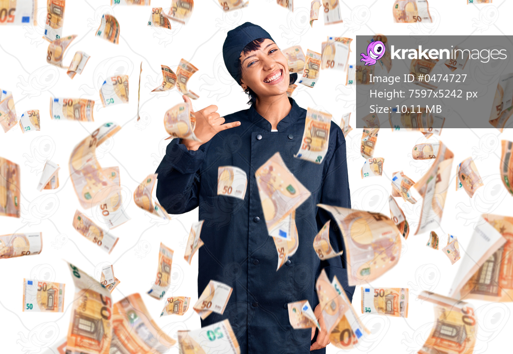 Young brunette woman with short hair wearing professional cook uniform smiling doing phone gesture with hand and fingers like talking on the telephone. communicating concepts.