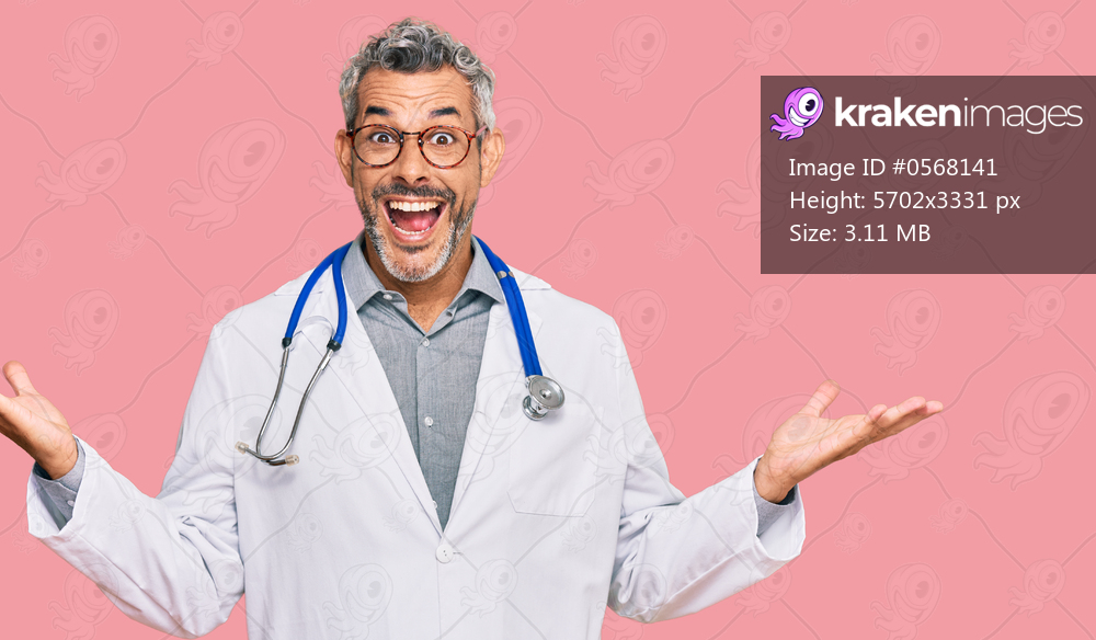 Middle age grey-haired man wearing doctor uniform and stethoscope celebrating victory with happy smile and winner expression with raised hands 