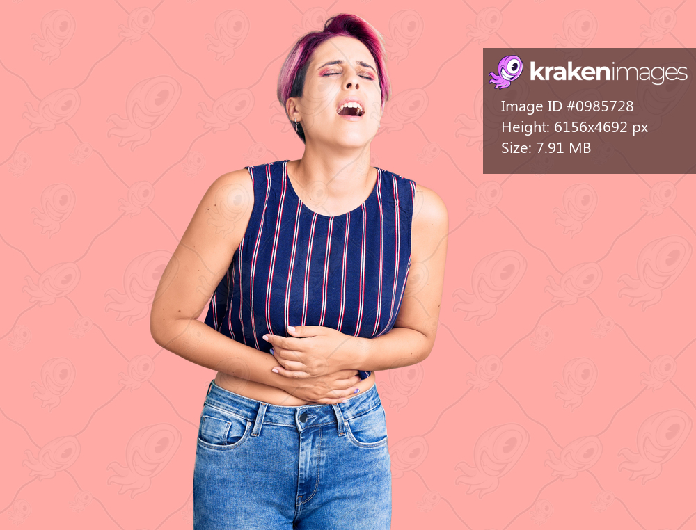 Young beautiful woman with pink hair wearing casual clothes with hand on stomach because nausea, painful disease feeling unwell. ache concept. 