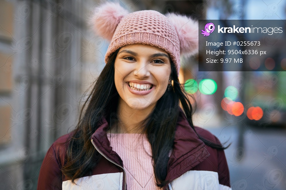 Young hispanic girl smiling happy standing at the city.