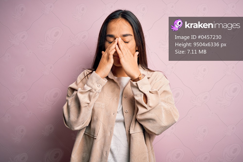 Young beautiful asian woman wearing casual shirt standing over pink background rubbing eyes for fatigue and headache, sleepy and tired expression. Vision problem