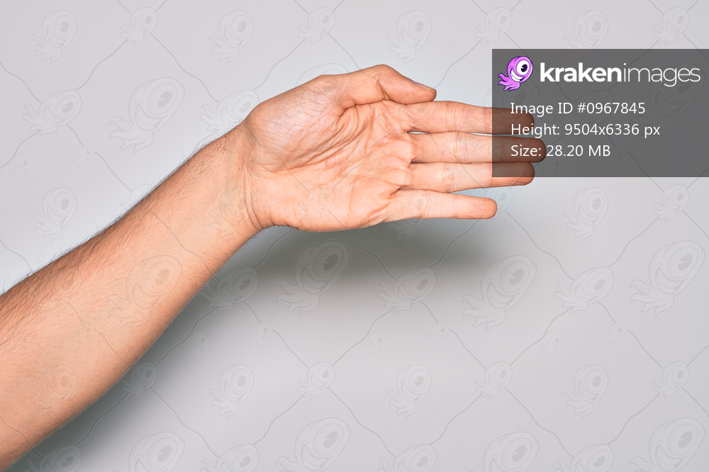 Hand of caucasian young man showing fingers over isolated white background stretching and reaching with open hand for handshake, showing palm