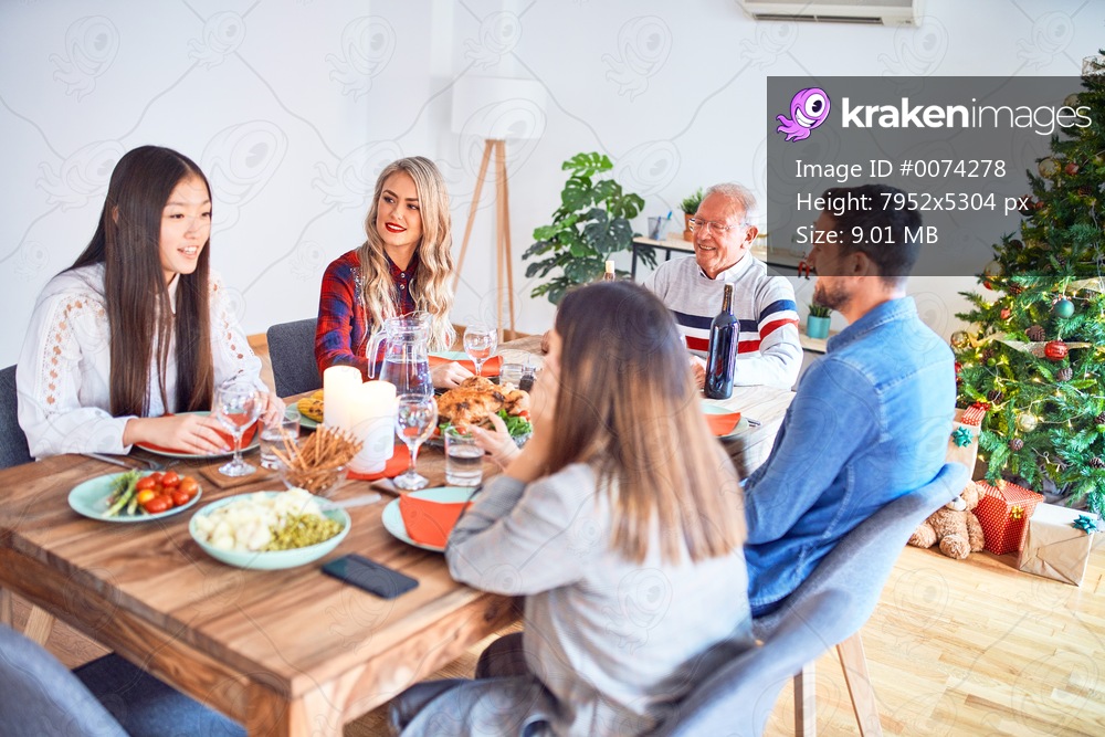 Beautiful family meeting smiling happy and confident. Eating roasted turkey celebrating Christmas at home