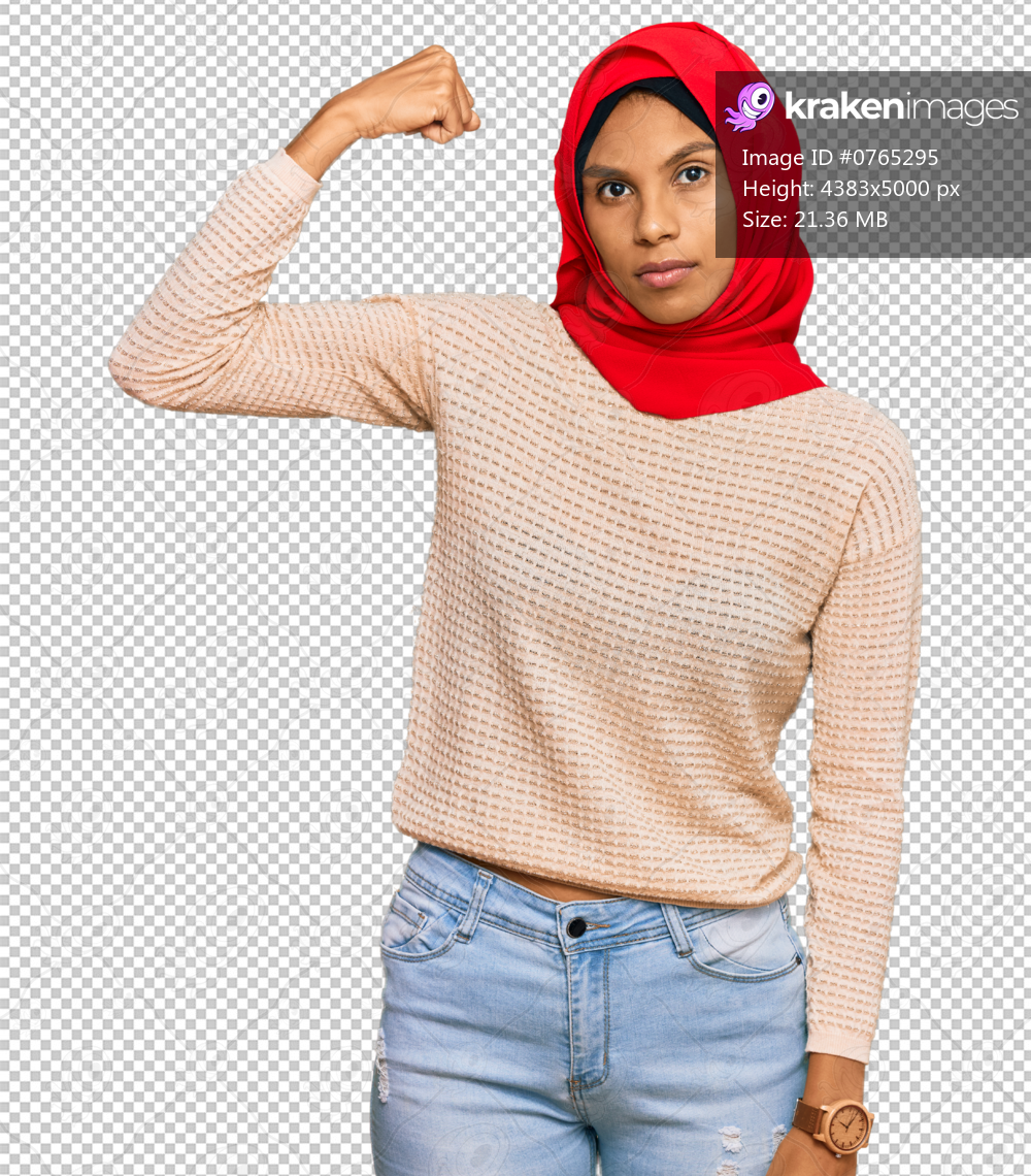 Young african american woman wearing traditional islamic hijab scarf strong person showing arm muscle, confident and proud of power