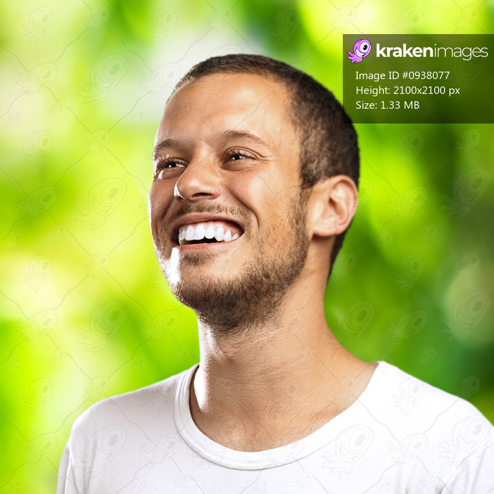 young man smiling on a green forest background