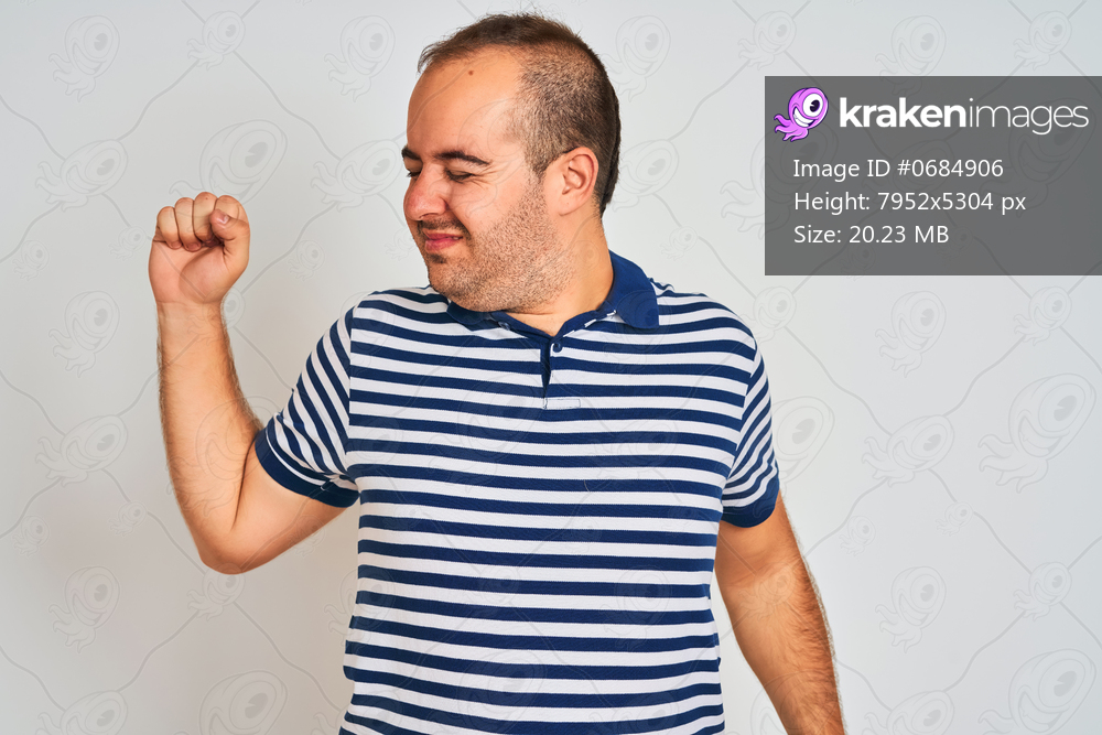 Young man wearing casual striped polo standing over isolated white background stretching back, tired and relaxed, sleepy and yawning for early morning