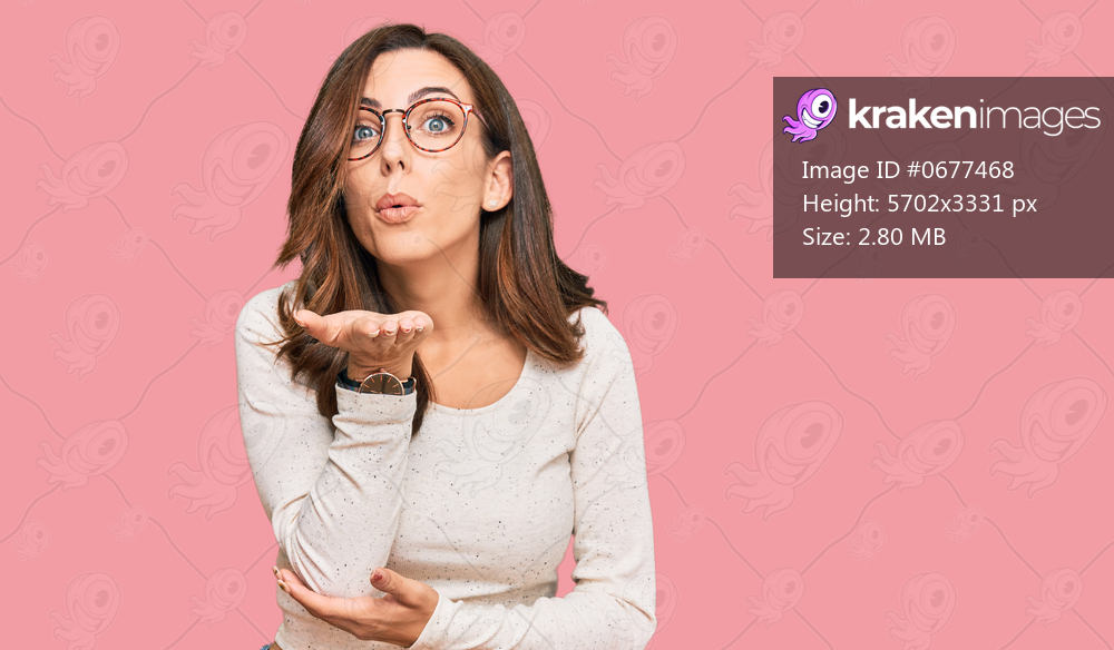 Young brunette woman wearing casual clothes and glasses looking at the camera blowing a kiss with hand on air being lovely and sexy. love expression. 