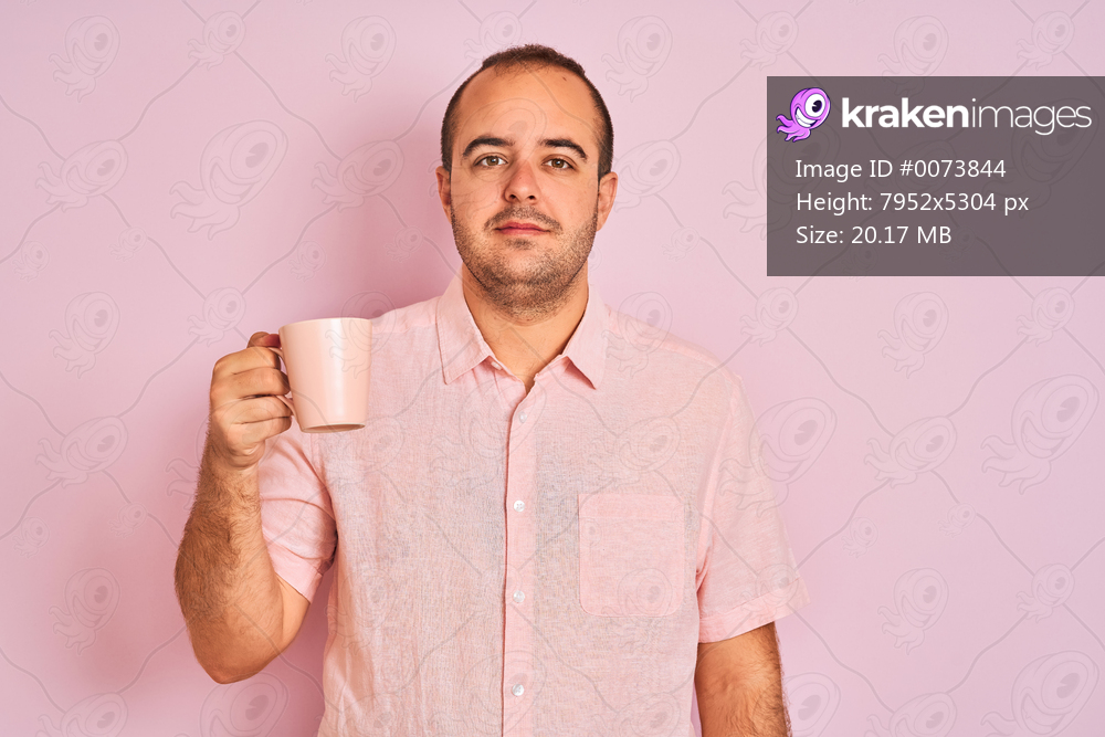 Young man drinking cup of coffee standing over isolated pink background with a confident expression on smart face thinking serious