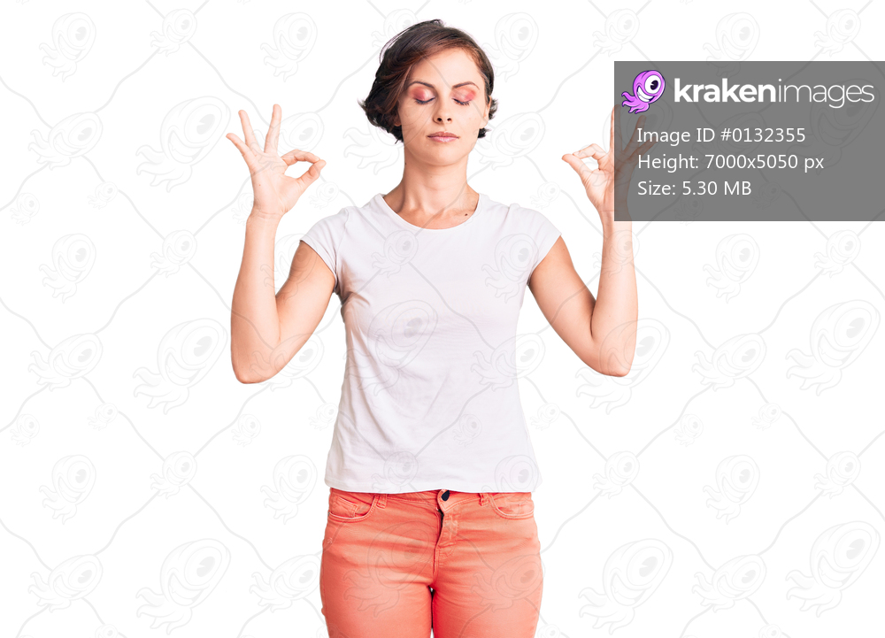Beautiful young woman with short hair wearing casual clothes relax and smiling with eyes closed doing meditation gesture with fingers. yoga concept. 