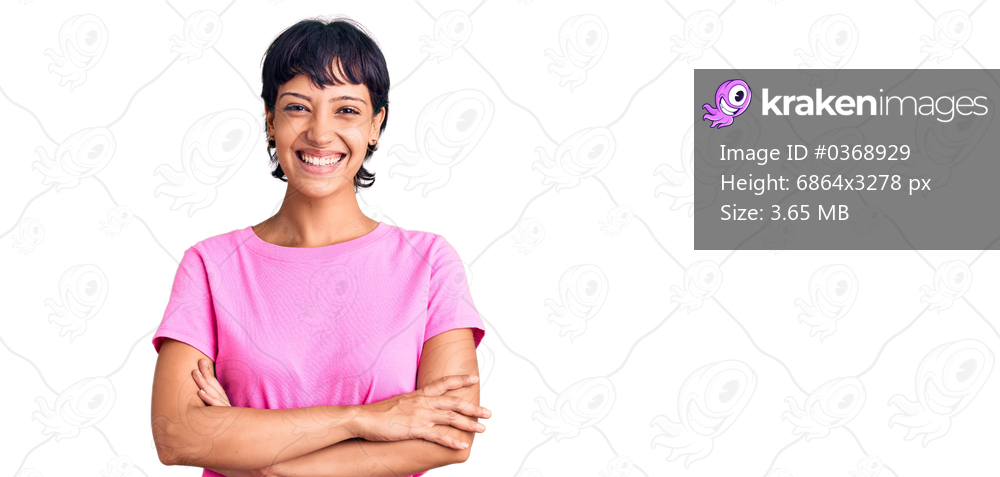 Young brunette woman with short hair wearing casual clothes happy face smiling with crossed arms looking at the camera. positive person. 