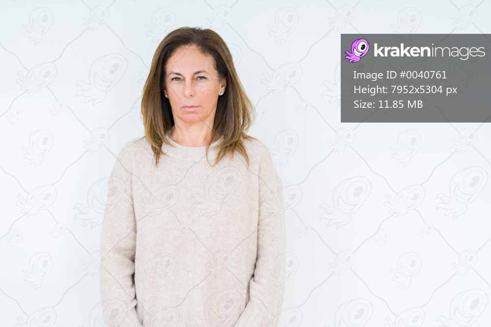 Beautiful middle age woman over isolated background skeptic and nervous, frowning upset because of problem. Negative person.