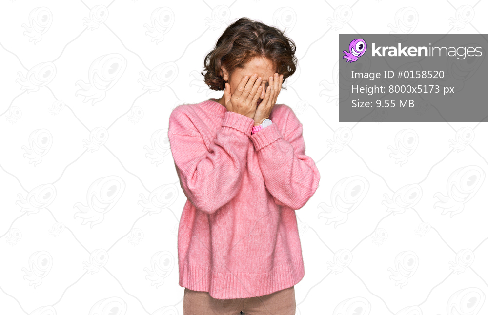 Young hispanic woman wearing casual clothes with sad expression covering face with hands while crying. depression concept. 