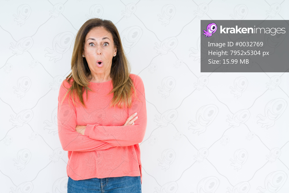 Beautiful middle age woman over isolated background afraid and shocked with surprise expression, fear and excited face.