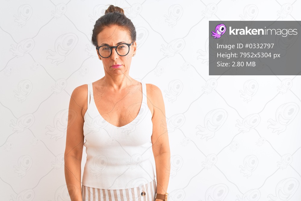 Middle age woman wearing casual t-shirt and glasses standing over isolated white background skeptic and nervous, frowning upset because of problem. Negative person.