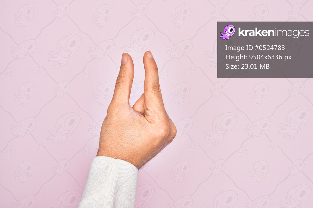 Hand of caucasian young man showing fingers over isolated pink background picking and taking invisible thing, holding object with fingers showing space