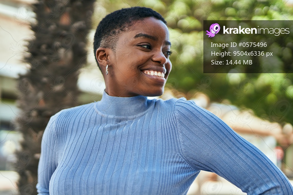 Young african american woman smiling happy standing at the city.