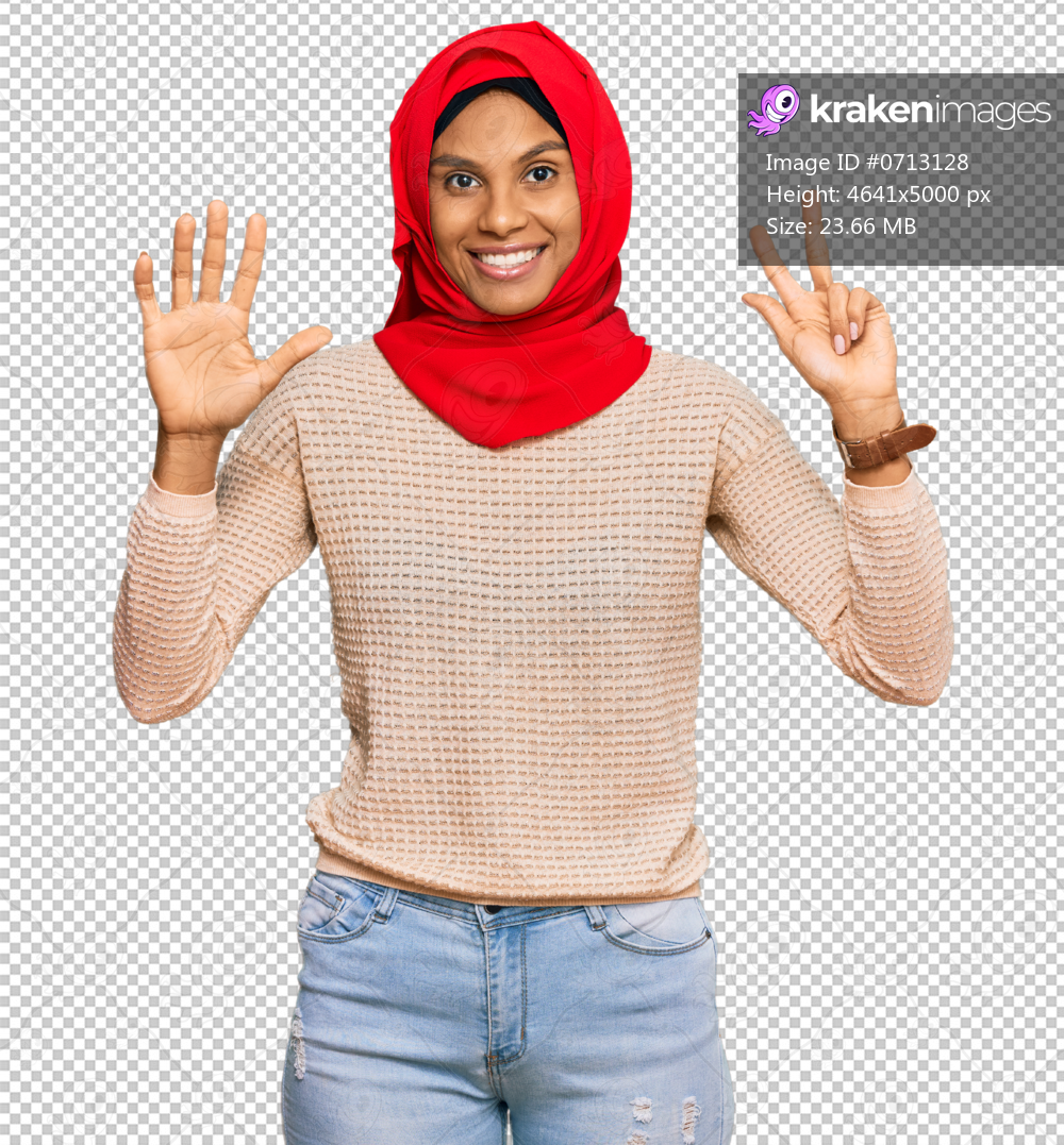 Young african american woman wearing traditional islamic hijab scarf showing and pointing up with fingers number eight while smiling confident and happy.