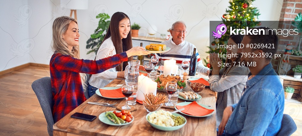 Beautiful family meeting smiling happy and confident. Eating roasted turkey celebrating Christmas at home
