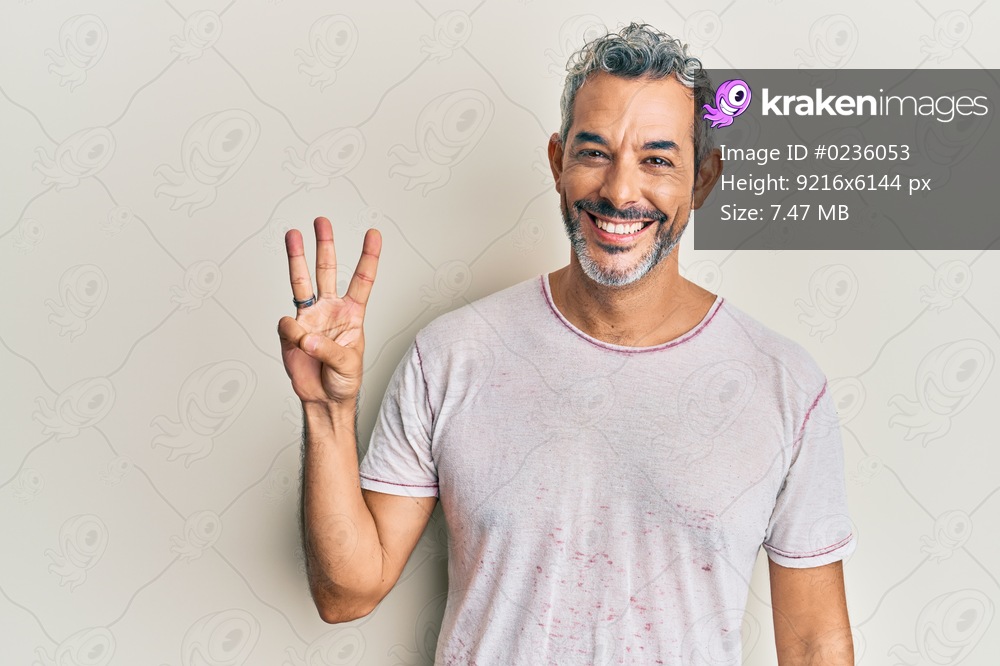 Middle age grey-haired man wearing casual clothes showing and pointing up with fingers number three while smiling confident and happy. 