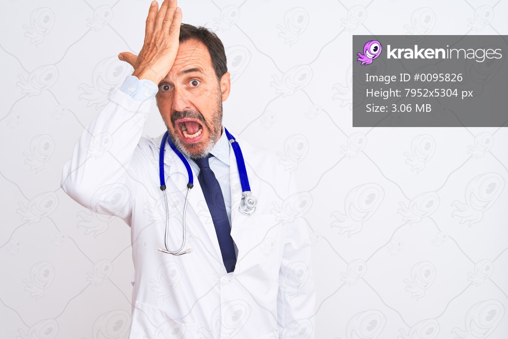 Middle age doctor man wearing coat and stethoscope standing over isolated white background surprised with hand on head for mistake, remember error. Forgot, bad memory concept.