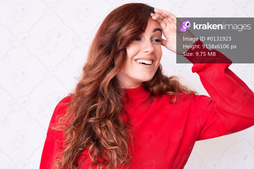 Young beautiful woman wearing casual clothes very happy and smiling looking far away with hand over head. searching concept. 