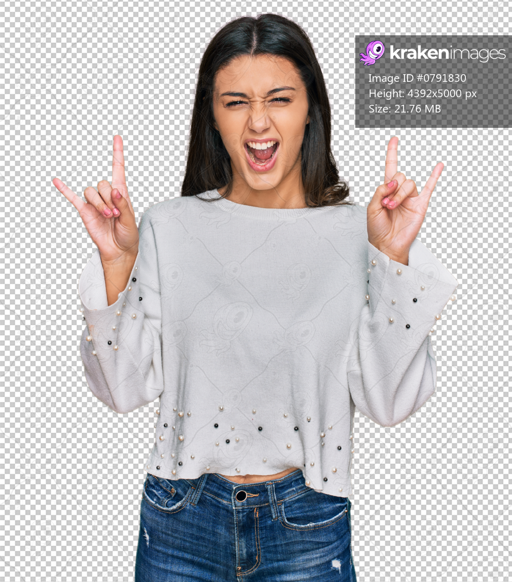 Young hispanic girl wearing casual clothes shouting with crazy expression doing rock symbol with hands up. music star. heavy concept.